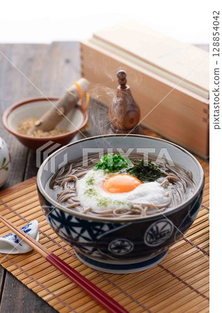 Steaming grated yam soba noodles Japanese style soba dish with egg yolk and spring onion 128854042