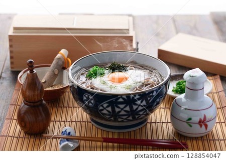 Steaming grated yam soba noodles Japanese style soba dish with egg yolk and spring onion 128854047