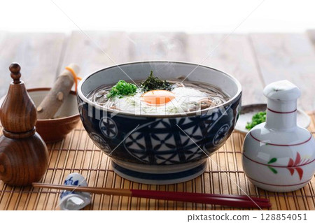 Steaming grated yam soba noodles Japanese style soba dish with egg yolk and spring onion 128854051
