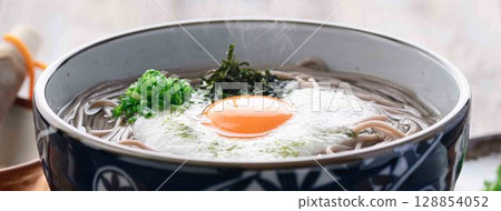 Steaming grated yam soba noodles Japanese style soba dish with egg yolk and spring onion Steaming grated yam soba noodles Japanese style soba dish with egg yolk and spring onion 128854052