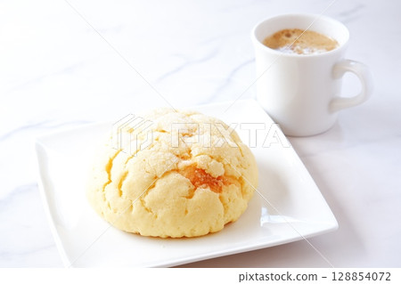 Melon bread and coffee - Enjoy a snack with some delicious melon bread and freshly brewed coffee Melon bread and coffee - Enjoy a snack with some delicious melon bread and freshly brewed coffee 128854072