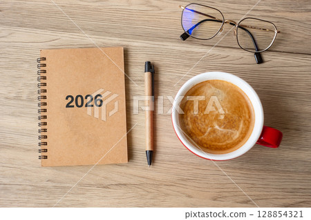 2026 notebook and coffee cup on wood table, Top view and copy space. Xmas, Happy New Year, Goals, Resolution, To do list, Strategy and Plan concept 128854321