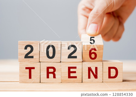 hand flipping block 2025 to 2026 TREND text on table. Resolution, idea, goal, motivation, reboot, business and New Year holiday concepts hand flipping block 2025 to 2026 TREND text on table. Resolution, idea, goal, motivation, reboot, business and New Year holiday concepts 128854330