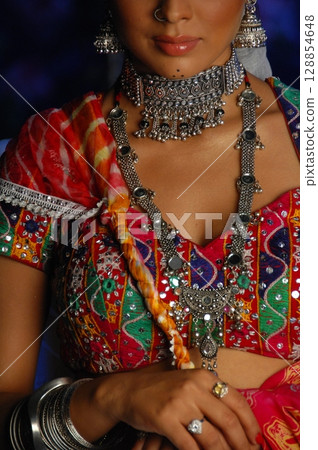 Elegant Indian Woman in Traditional Attire with Sensual Grace 128854648