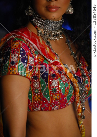 Elegant Indian Woman in Traditional Attire with Sensual Grace 128854649