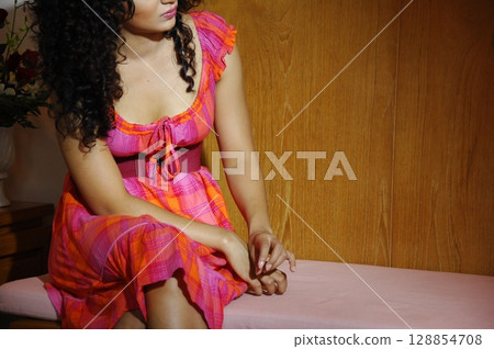Elegant Indian Woman in Traditional Attire with Sensual Grace 128854708