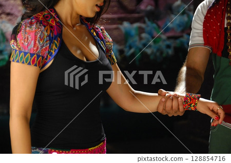 Elegant Indian Woman in Traditional Attire with Sensual Grace Elegant Indian Woman in Traditional Attire with Sensual Grace 128854716