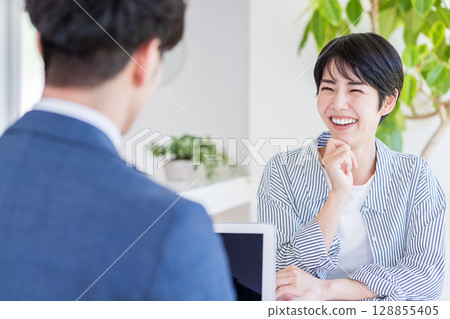 A housewife consults a financial planner. A housewife consults a financial planner. 128855405
