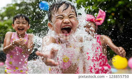 Joyful children splashing water in pool, enjoying sunny day together 128855750