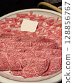 A plate with thinly sliced raw beef, ready to be used in shabu-shabu, sukiyaki or hot pot. 128856767