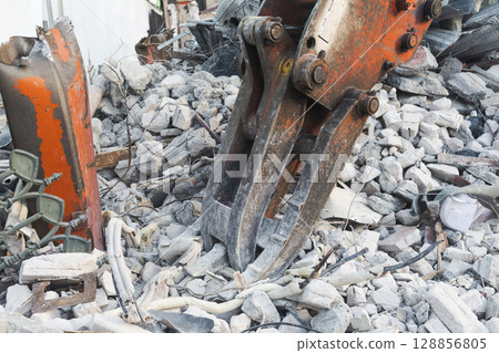 Demolition site with excavator and rubble Demolition site with excavator and rubble 128856805