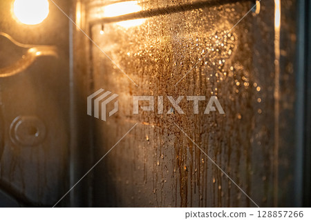 Close-up of dirty oven with greasy stains and baked-on food residue Close-up of dirty oven with greasy stains and baked-on food residue 128857266