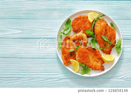 crispy parmesan crusted chicken cutlets, top view crispy parmesan crusted chicken cutlets, top view 128858136