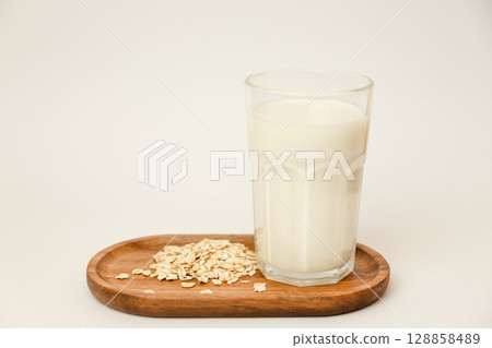 A glass of milk and oatmeal. Quick breakfast. Ingredients for oatmeal A glass of milk and oatmeal. Quick breakfast. Ingredients for oatmeal 128858489