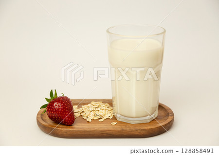 Ingredients for a healthy breakfast. Strawberry, oatmeal and milk on a white background Ingredients for a healthy breakfast. Strawberry, oatmeal and milk on a white background 128858491
