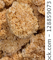 Closeup of dehydrated snow fungus. Also known as white fungus, silver ear mushroom, or snow ear, it is a type of edible fungus widely used in Chinese cuisine and traditional medicine. 128859073