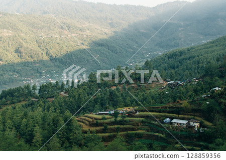 Terraced farming in Nepal. Village on a terraced hill during Annapurna Circuit Trek in Himalayas, Annapurna Conservation Area, Nepal. Rise fields. Agricultural concept 128859356