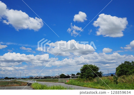 Rural landscape with blue sky and white clouds 128859634