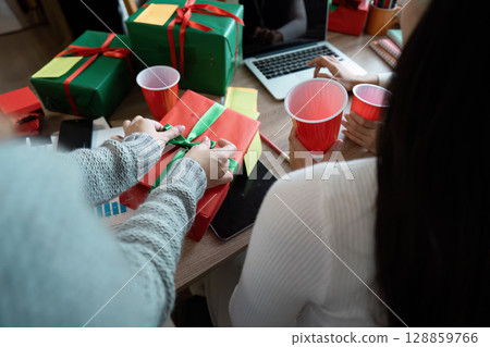 Festive Christmas Office Celebration with Gifts and Decorations for a Joyful Holiday Atmosphere Festive Christmas Office Celebration with Gifts and Decorations for a Joyful Holiday Atmosphere 128859766
