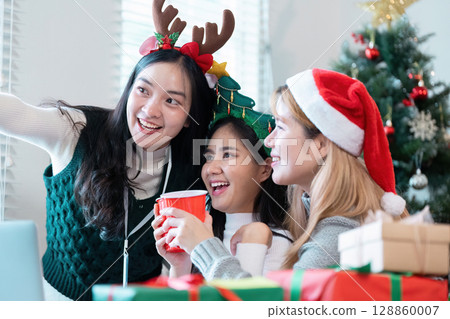 Festive Business Christmas Party with Colleagues Celebrating in Office with Decorations and Holiday Cheer Festive Business Christmas Party with Colleagues Celebrating in Office with Decorations and Holiday Cheer 128860007