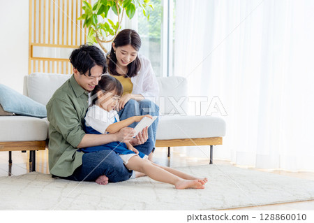Young family living room tablet 128860010