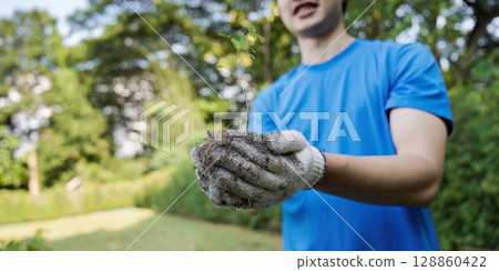 Young Volunteer Planting Tree Sapling in Park to Promote Environmental Conservation and Community Service 128860422