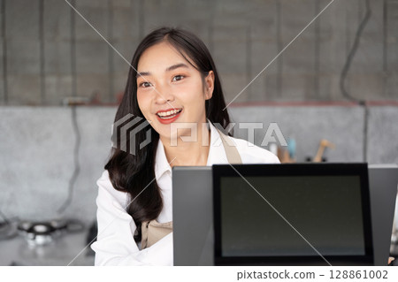 Young Entrepreneur Smiling in Modern Small Business Setting with Digital Tablet Young Entrepreneur Smiling in Modern Small Business Setting with Digital Tablet 128861002