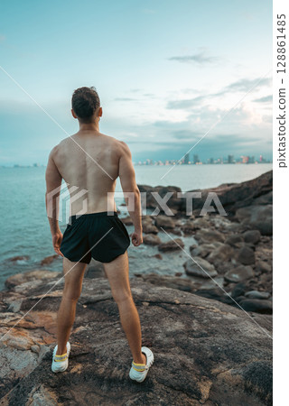 Athlete on rock showcases strength and nature challenge, Muscular athletic climber man at mountain peak radiates fitness and rugged success Athlete on rock showcases strength and nature challenge, Muscular athletic climber man at mountain peak radiates fitness and rugged success 128861485