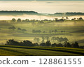 Misty autumn morning over rolling green hills, Hegau, Baden-Wuerttemberg, Germany 128861555