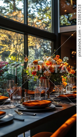 A table with a vase of flowers and a number of wine glasses and plates A table with a vase of flowers and a number of wine glasses and plates 128861618