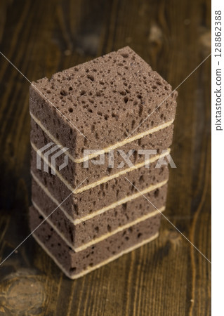 porous sponge for washing dirty dishes or other objects, a synthetic sponge with lots of holes for good foaming of detergents and is used for cleaning 128862388