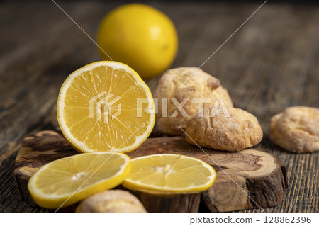 biscuits with pieces of yellow lemon, yellow lemon and shortbread biscuits with citrus flavor, closeup biscuits with pieces of yellow lemon, yellow lemon and shortbread biscuits with citrus flavor, closeup 128862396