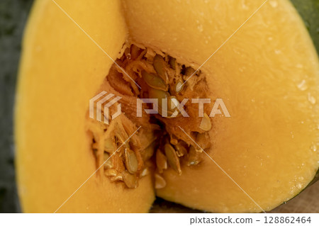 cut ripe pumpkin for cooking, cut into pieces sweet pumpkin in the kitchen, close up cut ripe pumpkin for cooking, cut into pieces sweet pumpkin in the kitchen, close up 128862464