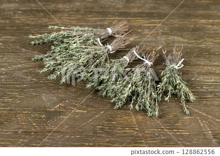 green thyme for use in cooking and folk medicine, thyme spices lying on a wooden table during drying green thyme for use in cooking and folk medicine, thyme spices lying on a wooden table during drying 128862556