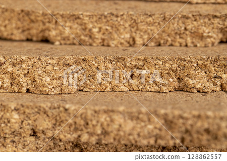 material that is obtained from the bark of a cork tree, closeup, side view material that is obtained from the bark of a cork tree, closeup, side view 128862557
