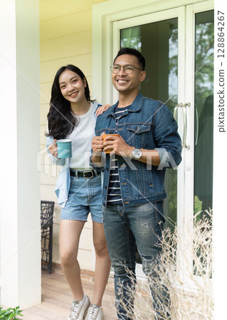 Couple bonding over coffee on a porch Couple bonding over coffee on a porch 128864267