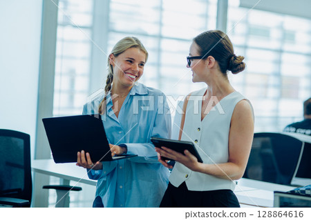 In modern offices, professionals collaborate to reach common goals via teamwork and innovation 128864616