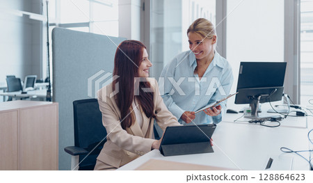 Professional Colleagues Actively Collaborating in a Modern Office Setting for Growth and Success Professional Colleagues Actively Collaborating in a Modern Office Setting for Growth and Success 128864623
