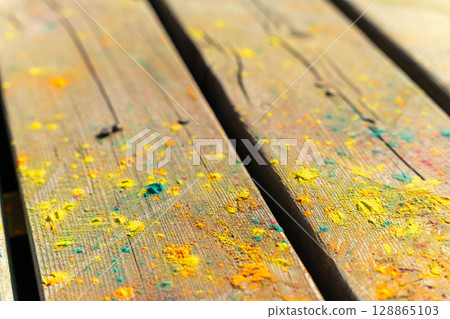 Colorful powder covering wooden planks in close-up view Colorful powder covering wooden planks in close-up view 128865103