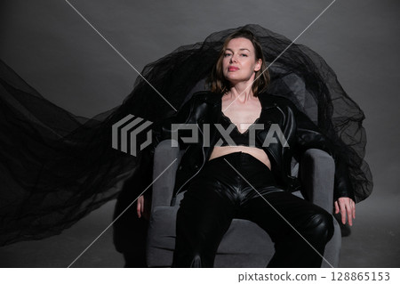 Slim woman in black leather suit and black lingerie 128865153