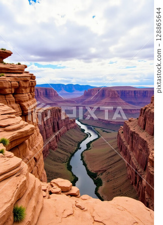 The breathtaking landscape showcases a winding river flowing gracefully between towering red rock formations under a vibrant sky filled with clouds Generative AI 128865644