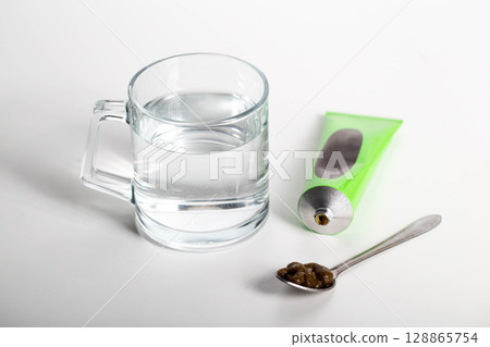 Tube with medicinal paste on herbs used in urology. Treatment of infectious inflammatory diseases of the urinary tract, close-up 128865754