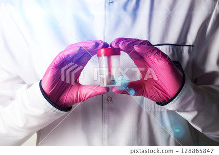 A doctor gastroenterologist holds a stool test in his hands. Concept of stool analysis for calprotectin, treatment of the gastrointestinal tract, close-up A doctor gastroenterologist holds a stool test in his hands. Concept of stool analysis for calprotectin, treatment of the gastrointestinal tract, close-up 128865847