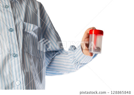 The child holds in his hand a container with a stool test. The concept of a study of stool analysis in children of worms and infections. Close-up, isolate The child holds in his hand a container with a stool test. The concept of a study of stool analysis in children of worms and infections. Close-up, isolate 128865848