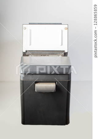 Black car refrigerator on a white background, mobile refrigerator, close-up Black car refrigerator on a white background, mobile refrigerator, close-up 128865859