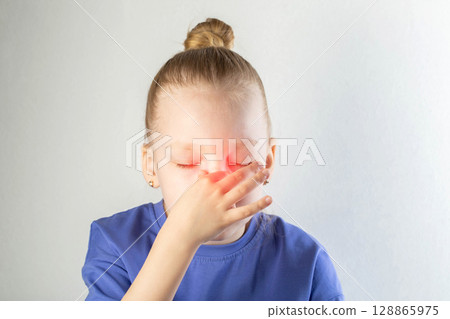 The girl holds her forehead with her hands, pain in her head. The concept of sinusitis in children. Inflammation of the maxillary sinuses. Treatment of sinusitis and nasal congestion, close-up The girl holds her forehead with her hands, pain in her head. The concept of sinusitis in children. Inflammation of the maxillary sinuses. Treatment of sinusitis and nasal congestion, close-up 128865975