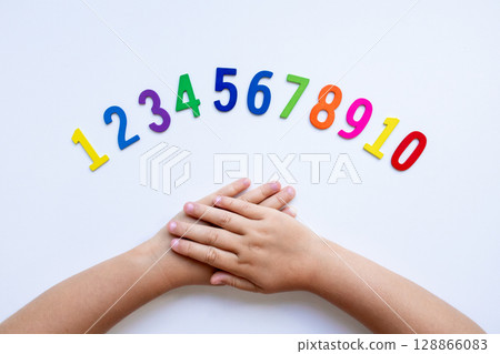 Child hands with colorful numbers on white background 128866083