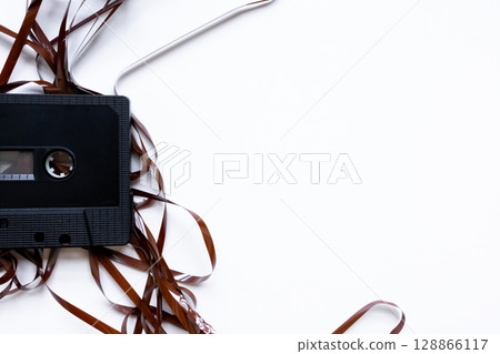 Vintage audio cassette with unraveled tape on white background 128866117