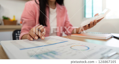 Work from Home Professional reviewing financial reports with smartphone Work from Home Professional reviewing financial reports with smartphone 128867105