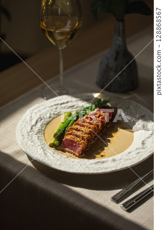 Grilled sliced tuna with asparagus and sesame Grilled sliced tuna with asparagus and sesame 128868567